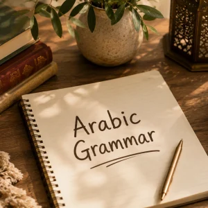 Notebook reading "Arabic Grammar" on a wooden desk with leather-bound books, a brass lantern, and a cup of tea